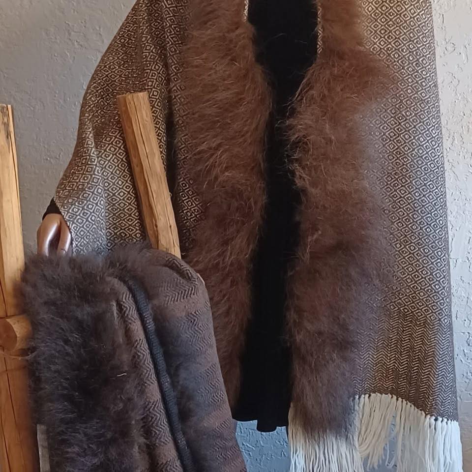 Cherokee Woven Spirits Studio - Cathy Abercrombie Textiles brown blanket/shawl with fuzzy edges and white fringe.