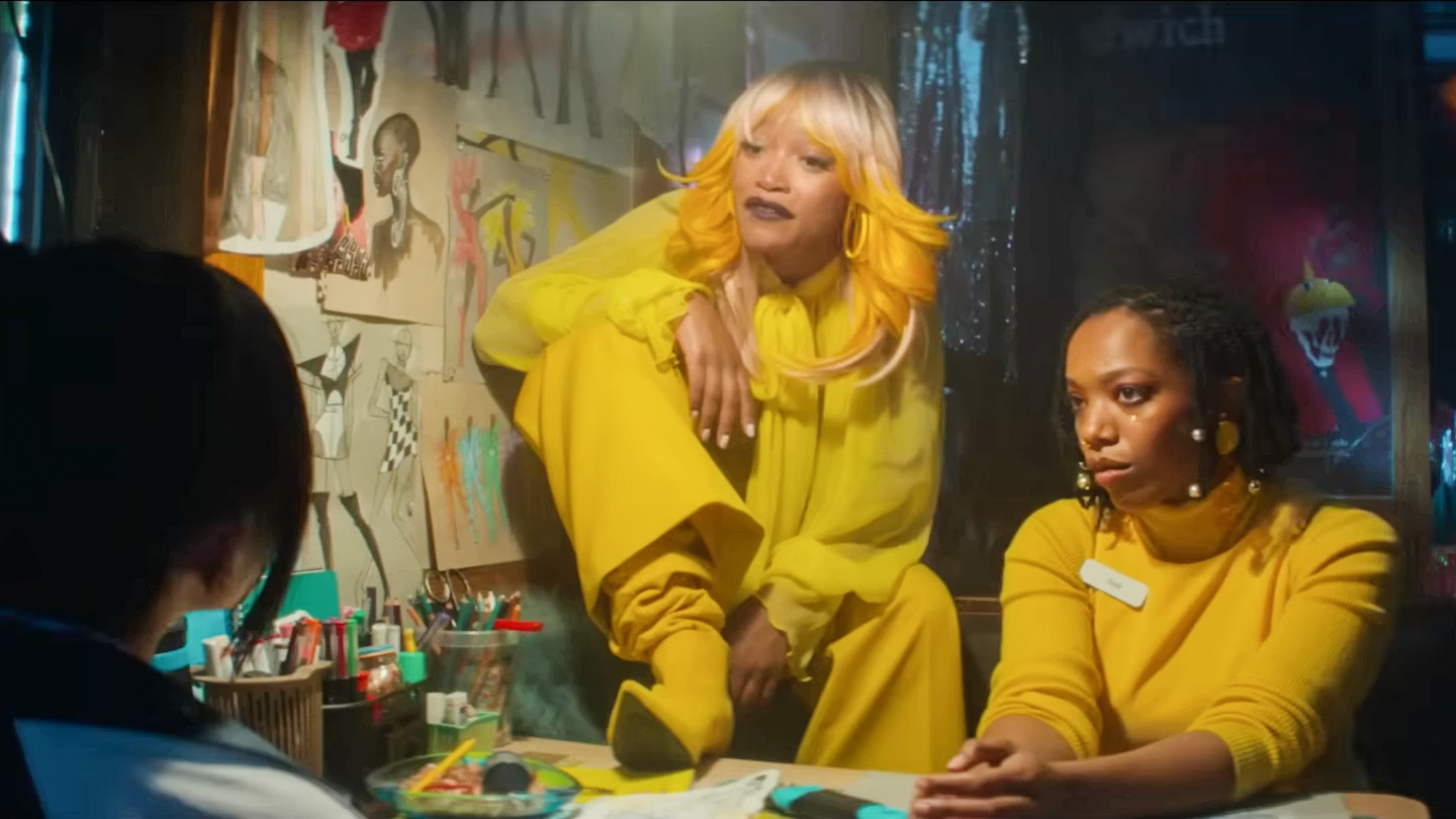 Keke Palmer dressed in yellow with a yellow booth on the table. Naomi Ackie is sitting next to her in a yellow turtle neck