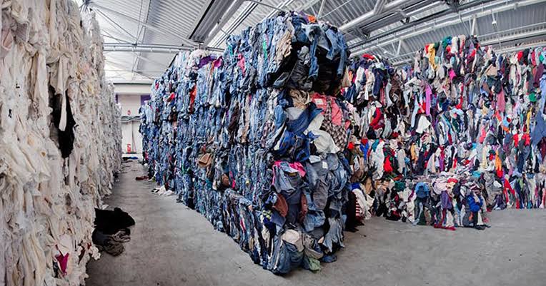 Brick-shaped compressed bundles of discarded garments prepared for textile handling